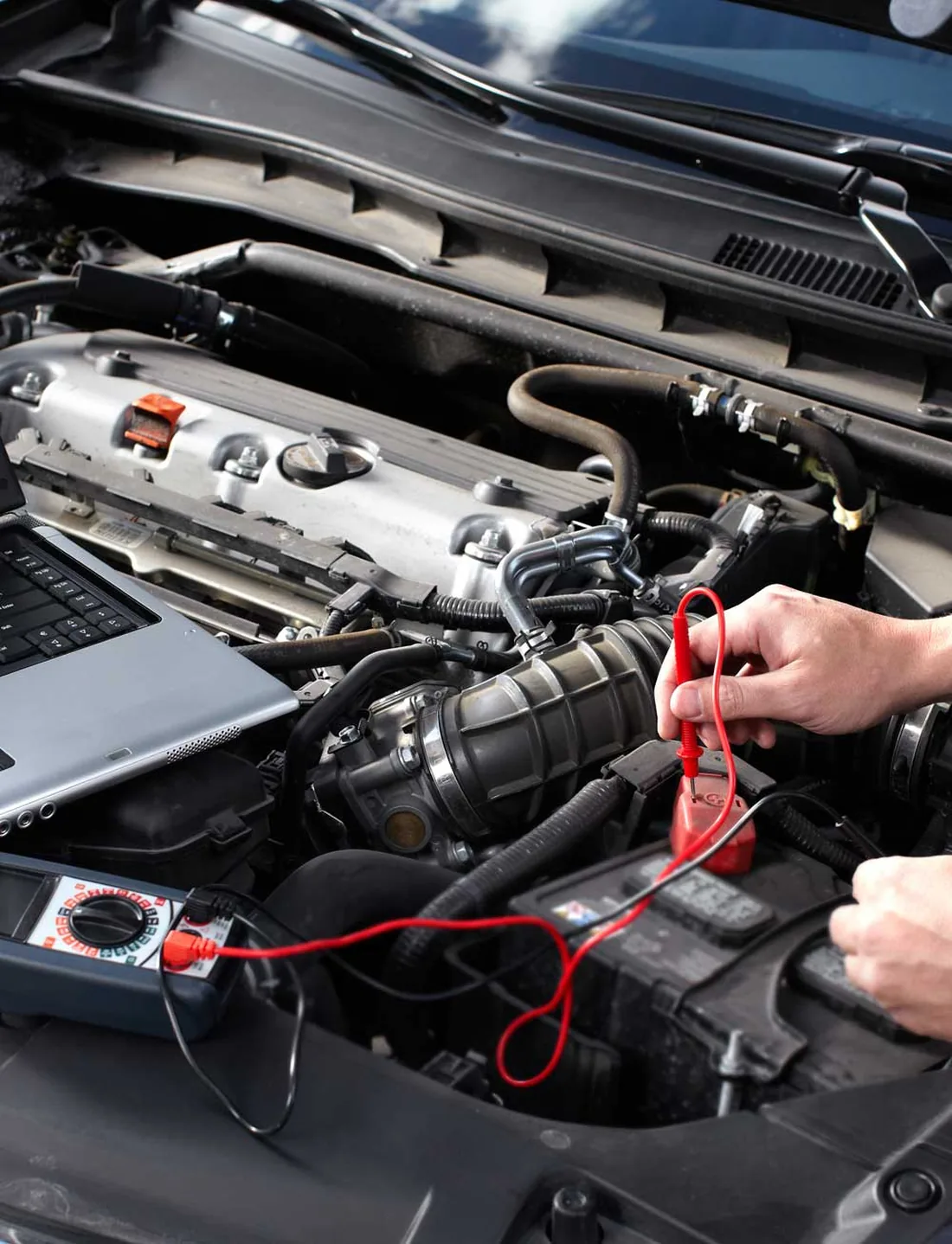 Franco testing and fitting a new car battery at a customer's home on the Gold Coast